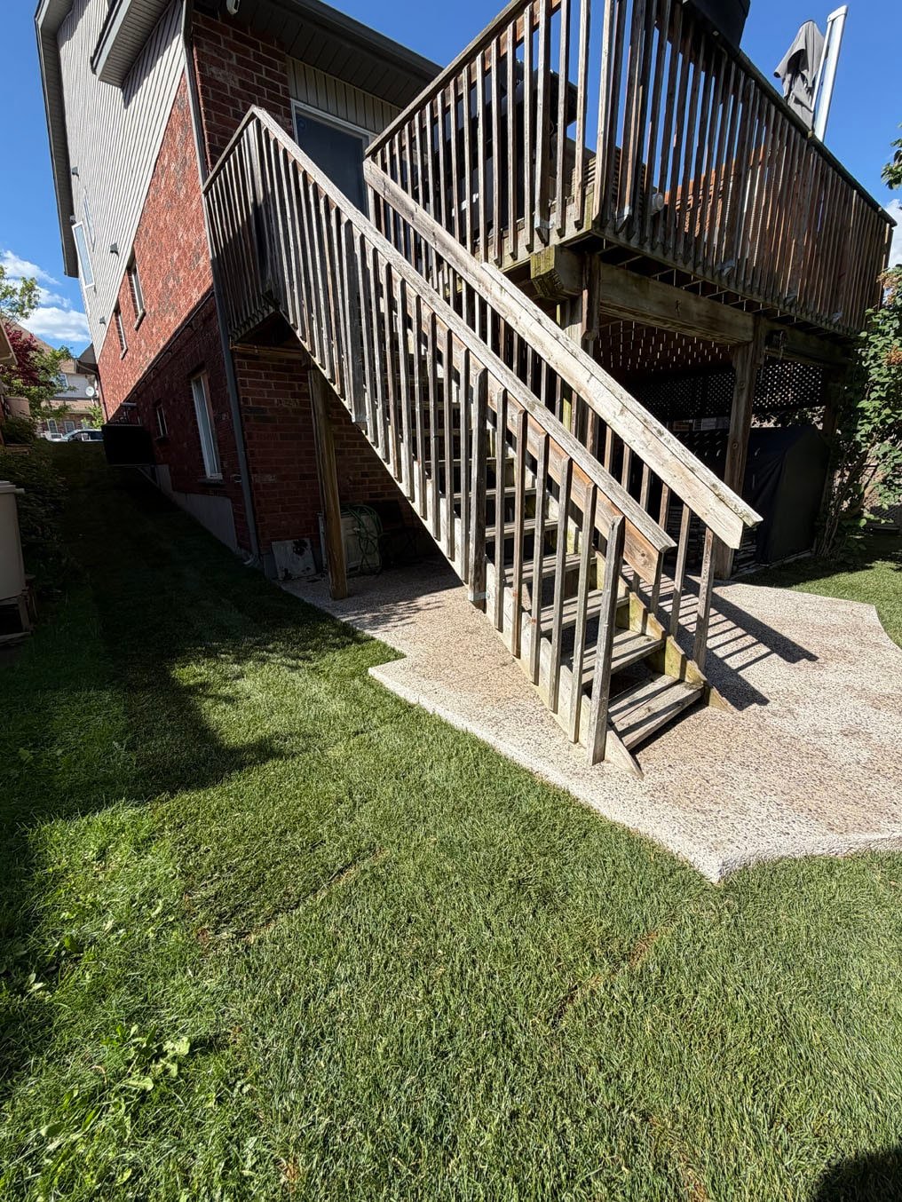 Sod Installation On Brisbane Drive, Kitchener 12 New sod fitted under the deck stairs and against the gravel pad at a Brisbane Drive home in Kitchener