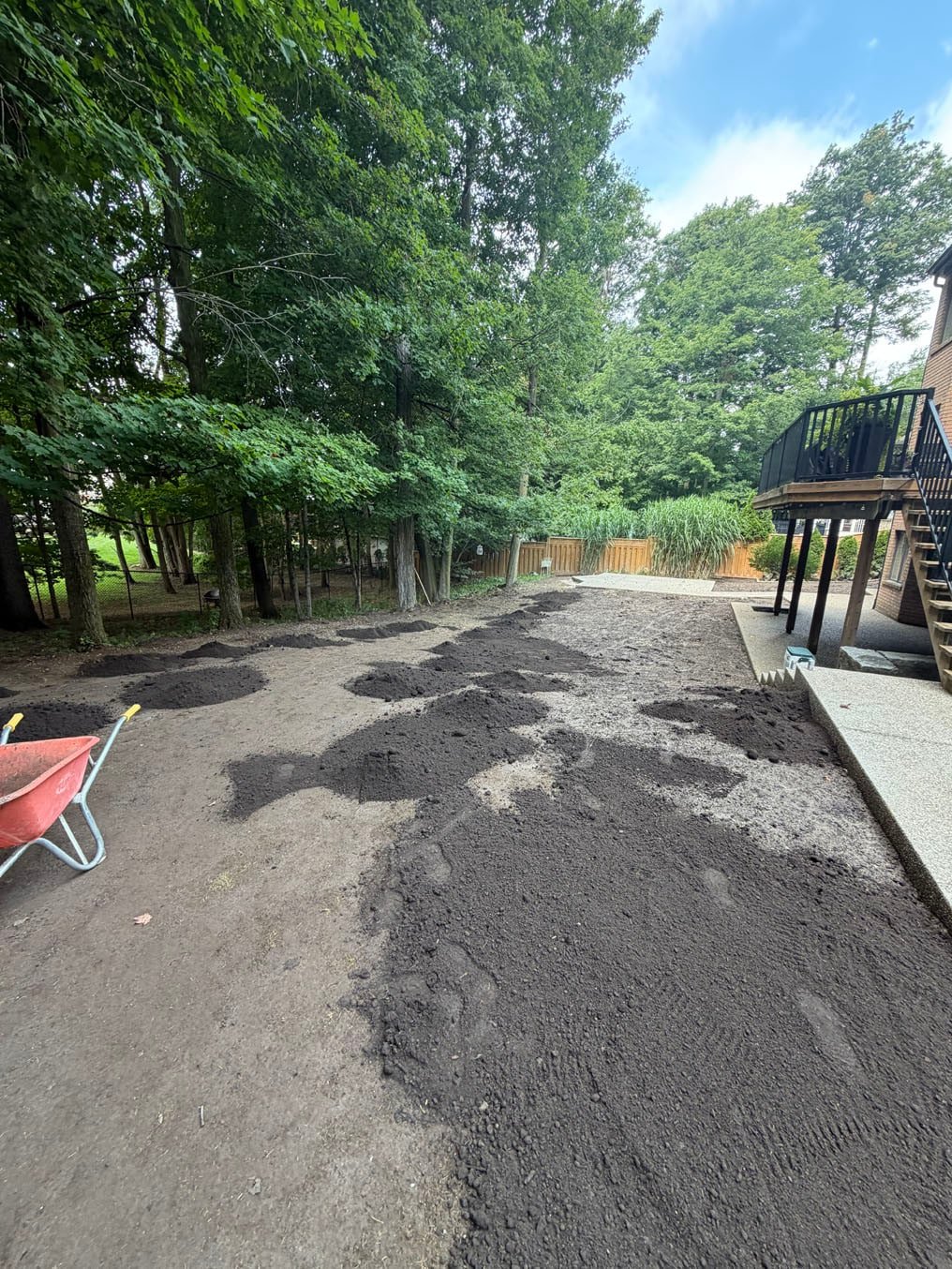 Fresh topsoil tipped in piles across the back yard for spreading on Carrington Place, Waterloo
