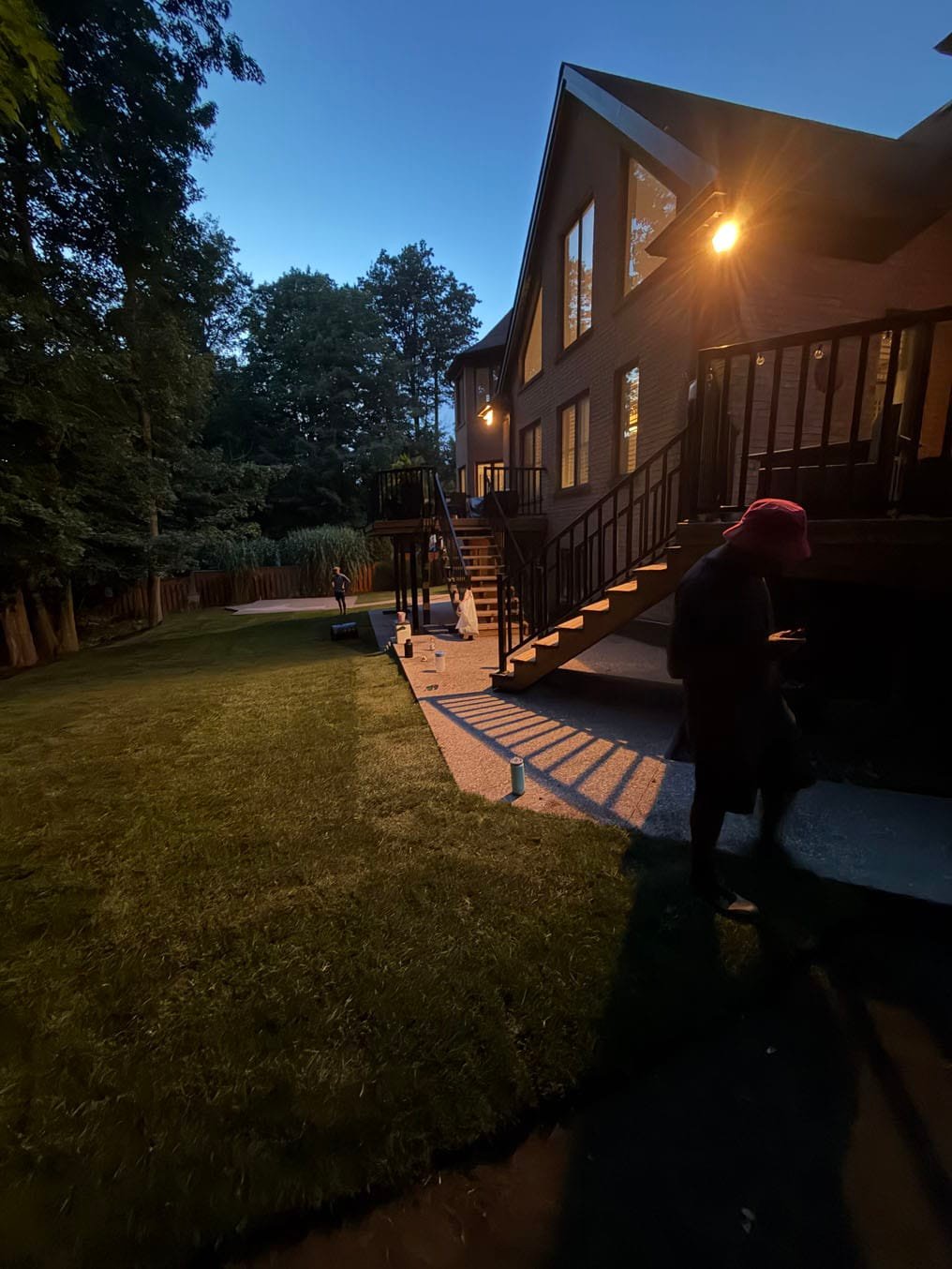 Sod Installation On Carrington Place, Waterloo 5 Finished sod back yard at dusk below the lit deck and stairs of a Carrington Place, Waterloo home