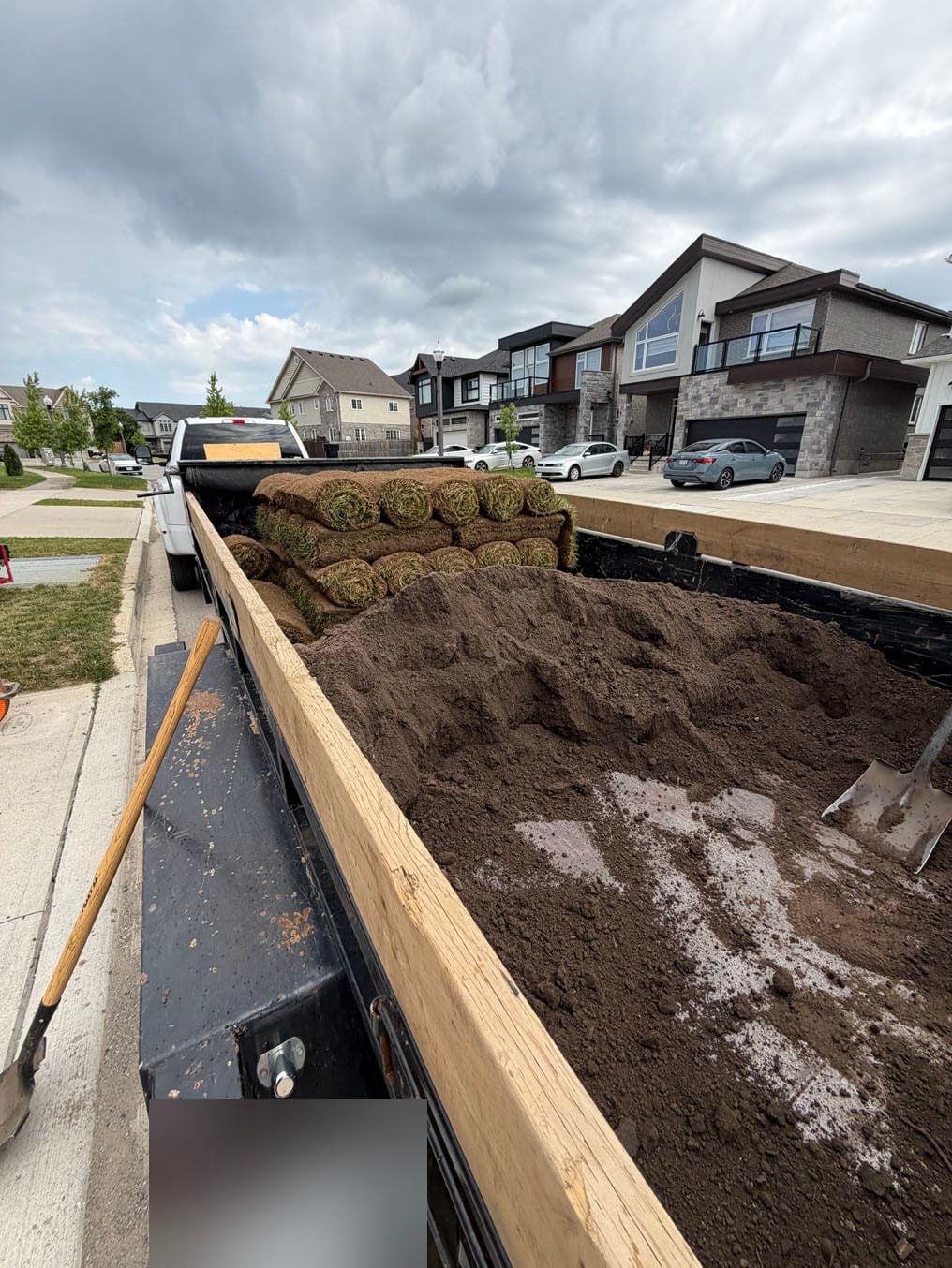 Top Benefits of Sod for a Better Lawn Fast 3 Fresh topsoil and stacked Kentucky bluegrass sod rolls on the crew trailer at the street outside the Doon South, Kitchener job