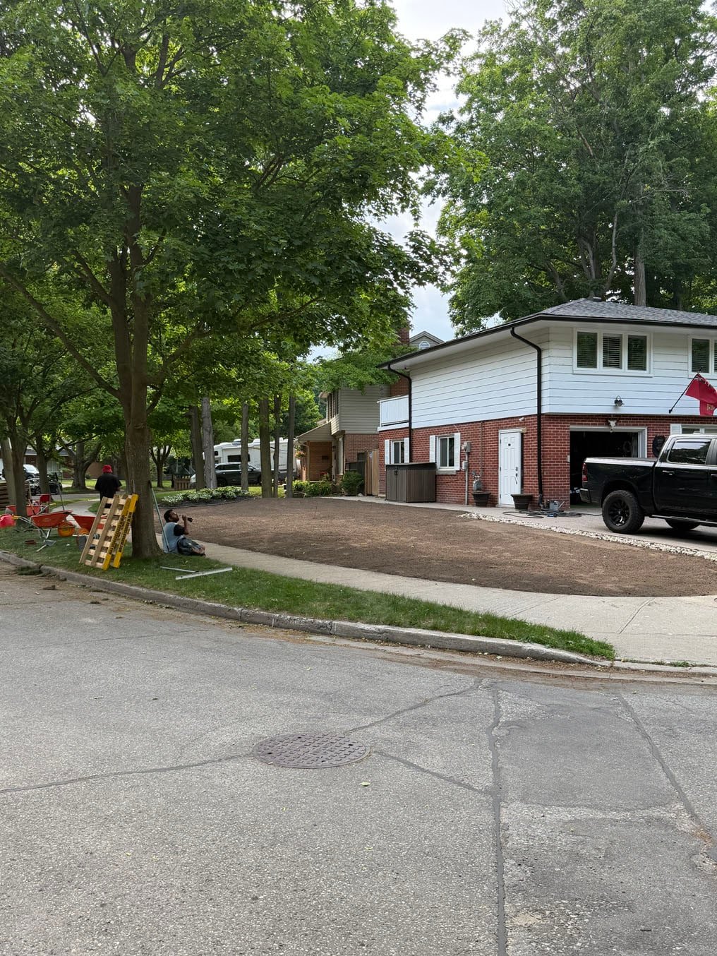 Fresh topsoil graded from the house to the sidewalk and ready for sod at a home in Forest Hills, Kitchener