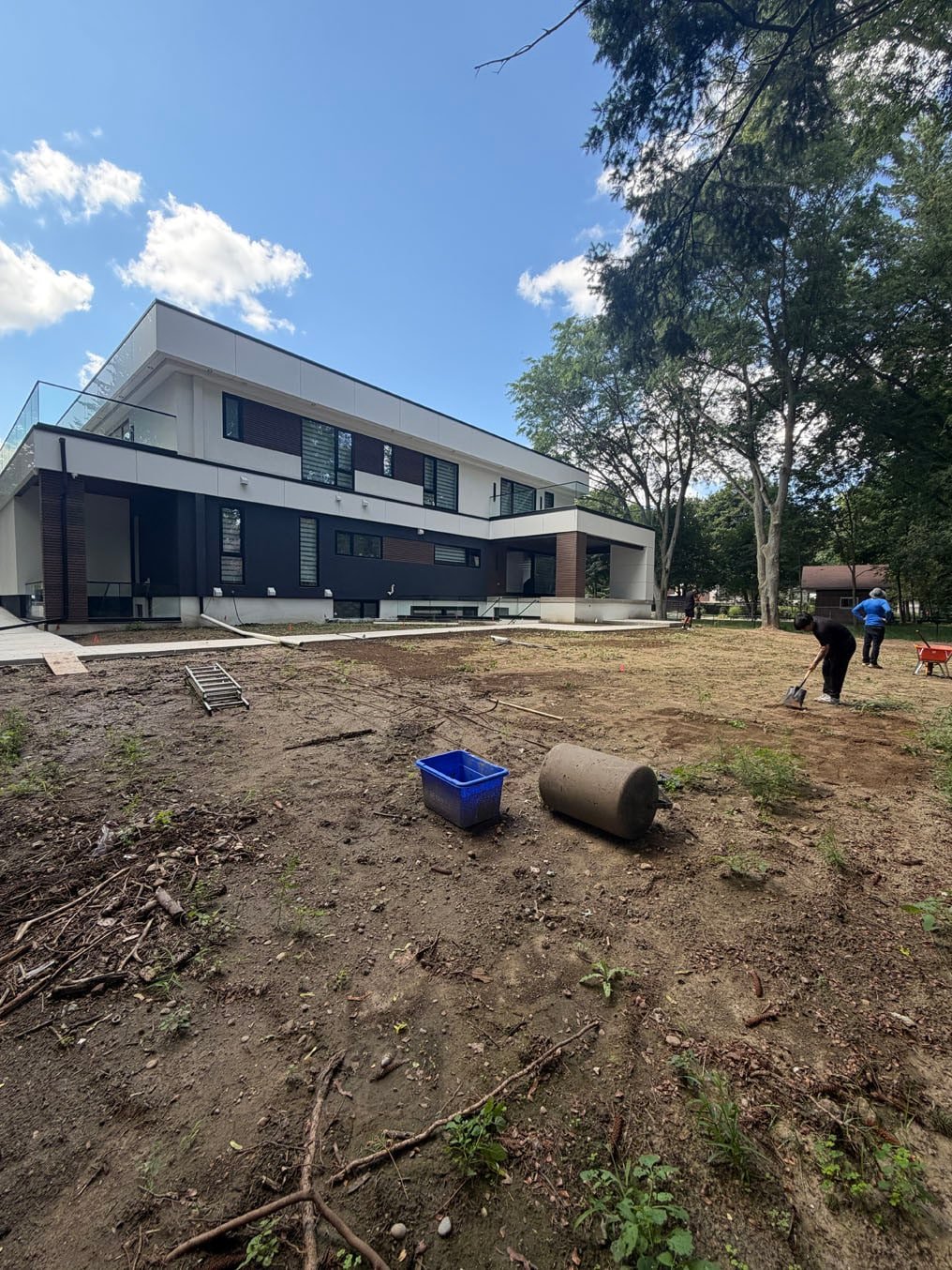 Sod Installation On Lexington Crescent, Waterloo 7 Right On Sod crew clearing branches and debris from the rough back yard of the new home on Lexington Crescent, Waterloo