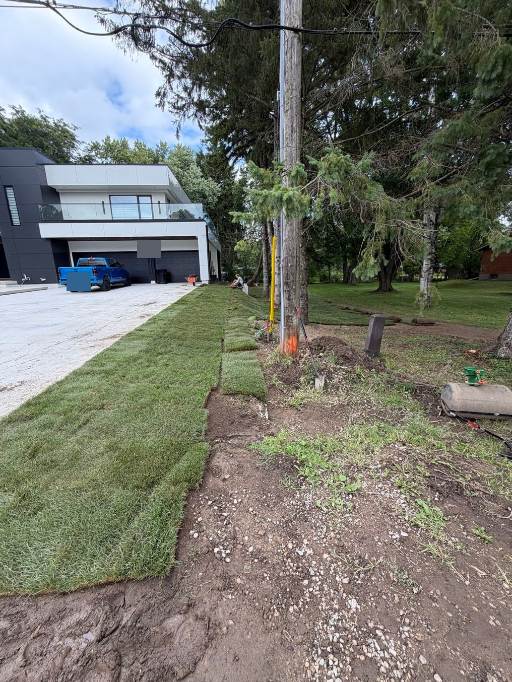 Sod Installation On Lexington Crescent, Waterloo 17 Strip of new sod laid beside the driveway on Lexington Crescent, Waterloo during the follow-up visit on 27 August