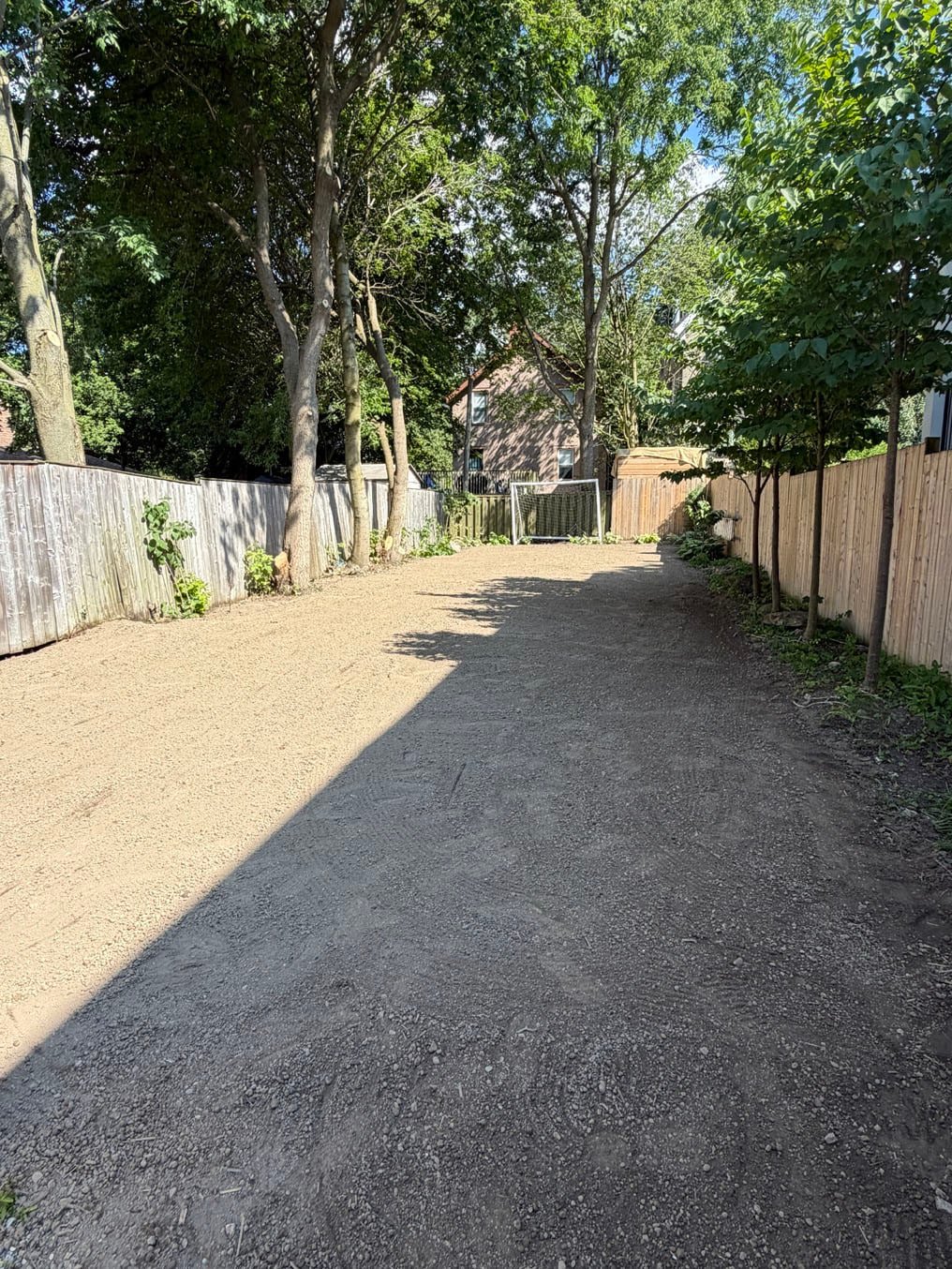 Fresh topsoil graded down the length of the back yard between the fences in Old University, Guelph