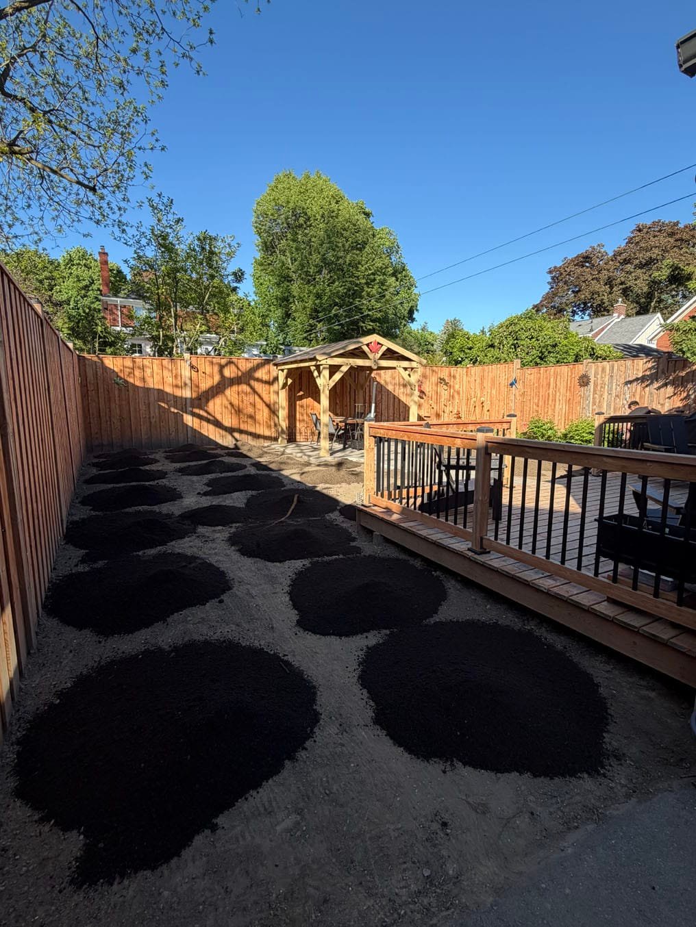 Heaps of fresh topsoil barrowed across a stripped back yard before spreading, Westmount, Waterloo