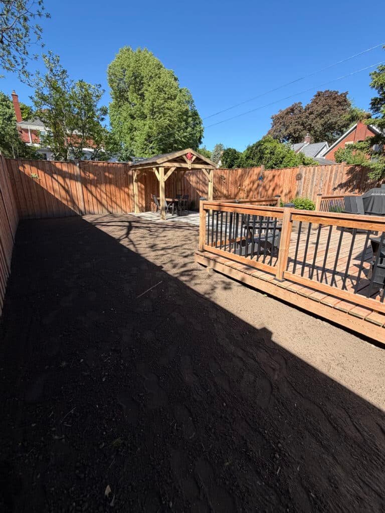 Fresh topsoil spread and graded from the deck to the gazebo in a Westmount, Waterloo back yard