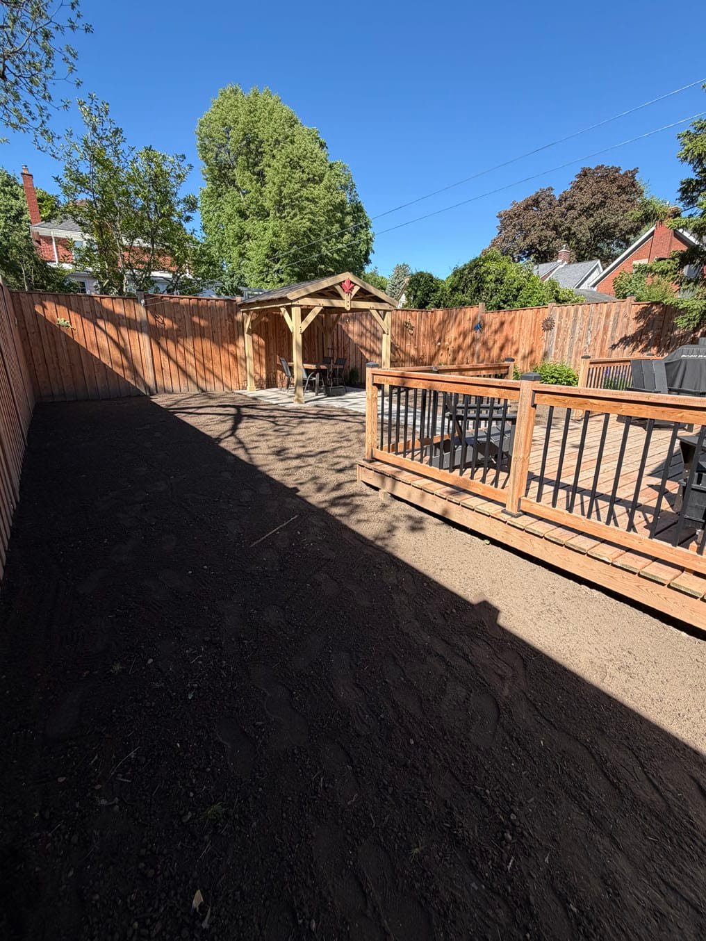 Fresh topsoil spread and graded from the deck to the gazebo in a Westmount, Waterloo back yard
